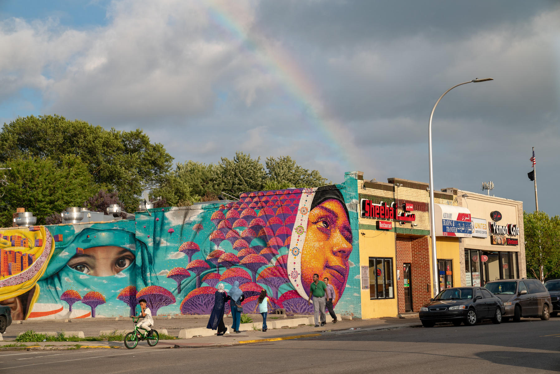 <div class="storycaption">
	<div class="galleryIntroTextArea holder">
		<div class="galleryIntroTextContent">
			<div class="galleryIntroTextContentInside">
				<div class="frishhead">
					MURAL 
				</div>
				<div class="frishsubhead">
					HAMTRAMCK, MICHIGAN 
				</div>
				<div class="frishtext">
					Hamtramck, long known as a blue collar Polish enclave surrounded by Detroit, has undergone a dramatic demographic shift. In November 2015 the city became the first to elect a Muslim-majority council in the United States. Originally settled by Germans, it became predominantly Polish in the 1910's, as immigrants moved in to work in the auto industry. Later waves of immigrants included those of Middle Eastern and South Asian descent, many Yemeni and Bengali. Of Hamtramck's population, nearly 43 percent are foreign born, according to recent data from the U.S. Census Bureau. More than 60 percent speak a language other than English at home. A mural honoring Yemeni Americans which graces the side of Sheeba Restaurant was created by Dasic Fernandez. It was commissioned by the Arab American and Chaldean Council and OneHamtramck, a coalition in the city that seeks to bring together residents representing dozens of cultural groups in the city. "I saw the buildings and I thought of uprooting our whole families when we migrate and then traveling forward," said Hasan Newash, a Palestinian-American who served on the mural committee. "It goes from all the pain in the eyes of the old man to the eyes of that woman, the hope, the purpose." Added Ahmed Al-Ammari, who serves on the OneHamtramck board of advisers, "The eyes of that young woman looking to the future gives us hope. Not just for Yemeni Americans but all." 
				</div>
				<div class="frishdate">
					PHOTOGRAPHED: 2019 
				</div>
			</div>
		</div>
	</div>
</div> : IMAGES : Ghosts of Segregation